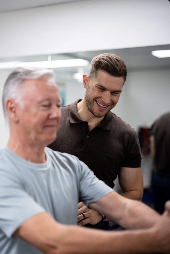 Chiropractor showing rehab exercises to patient