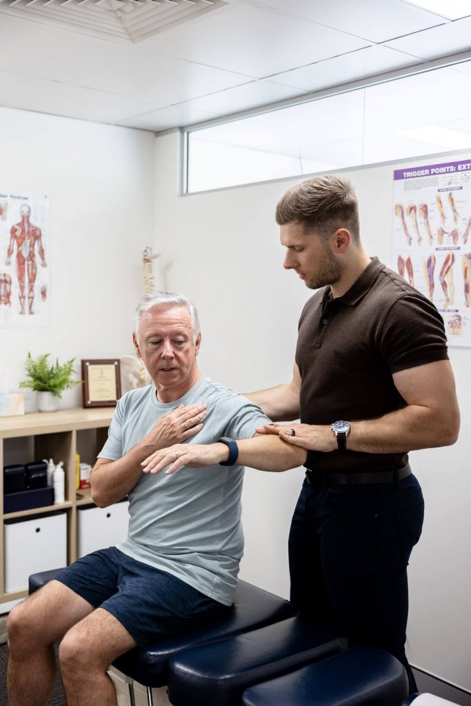 Chiropractor examining patient