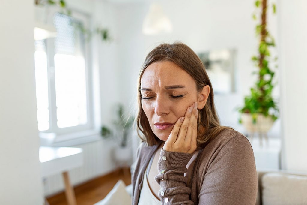 Young Woman Suffering From Terrible Strong Jaw Pain