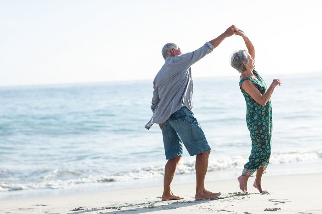 Senior couple dancing at the beach